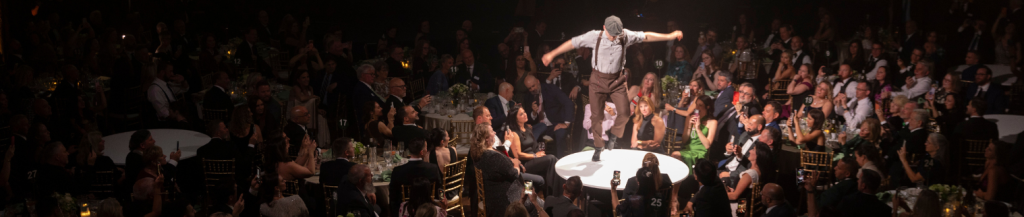 Irish dancer performing on a table amongst attendees at an event