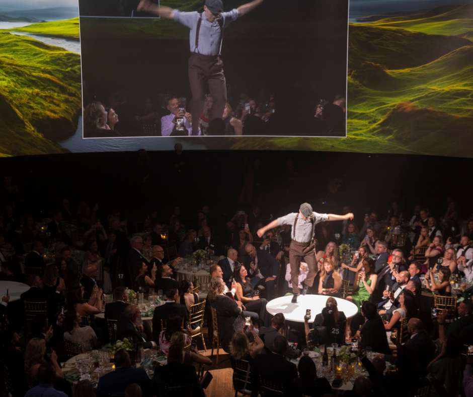 Irish dancer performing on a table amongst attendees at an event