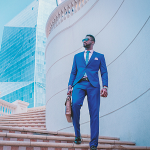 travel gift ideas: man in suit not wrinkled from travel, heading to meeting in beautiful outdoor setting