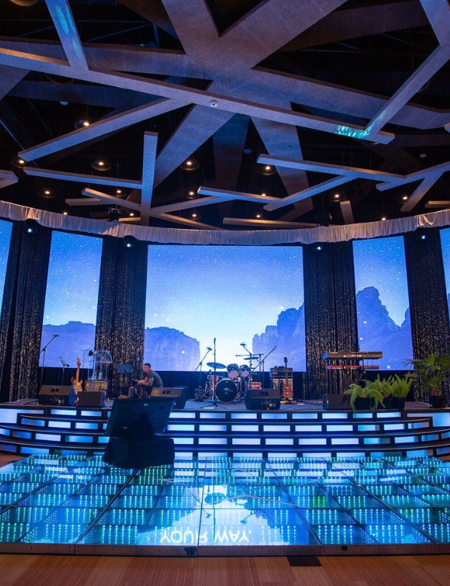 stage setup at a sales meeting with blue lights and a blue lighted floor