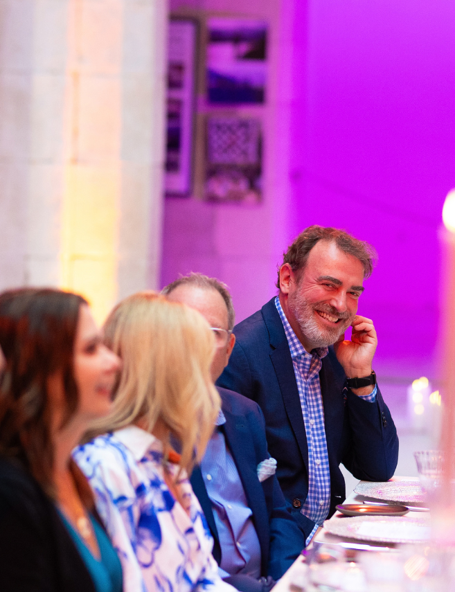 sales team members at a table enjoying dinner and company