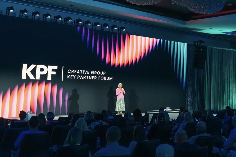 Speaker on the KPF Creative Group Key Partner Forum stage in front of a seated audience.