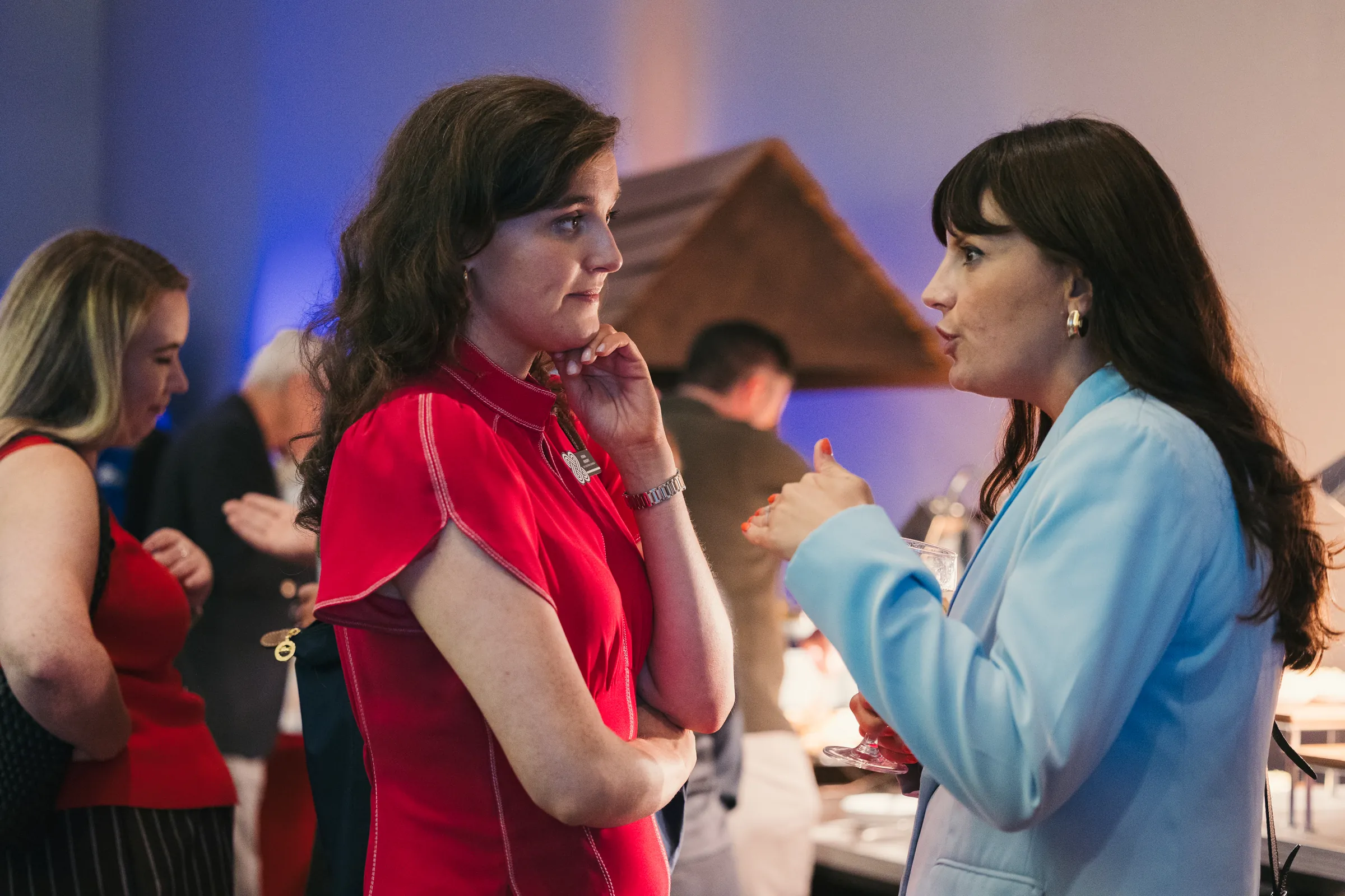 Two attendees deep in conversation during a Key Partner Forum networking event.