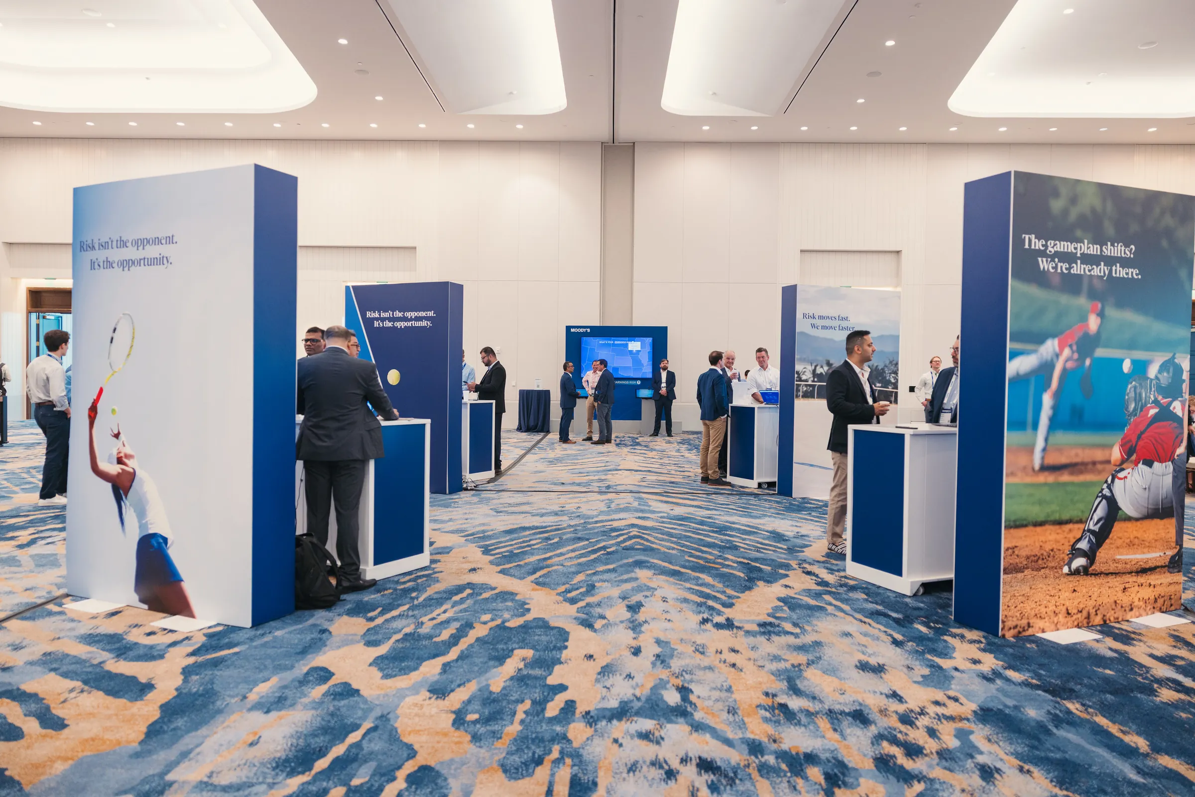 Attendees exploring Moody’s product stations at the Exceedance 2026 Innovation Showcase.